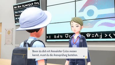 Gameplay screenshot of trainer outside of a gym.